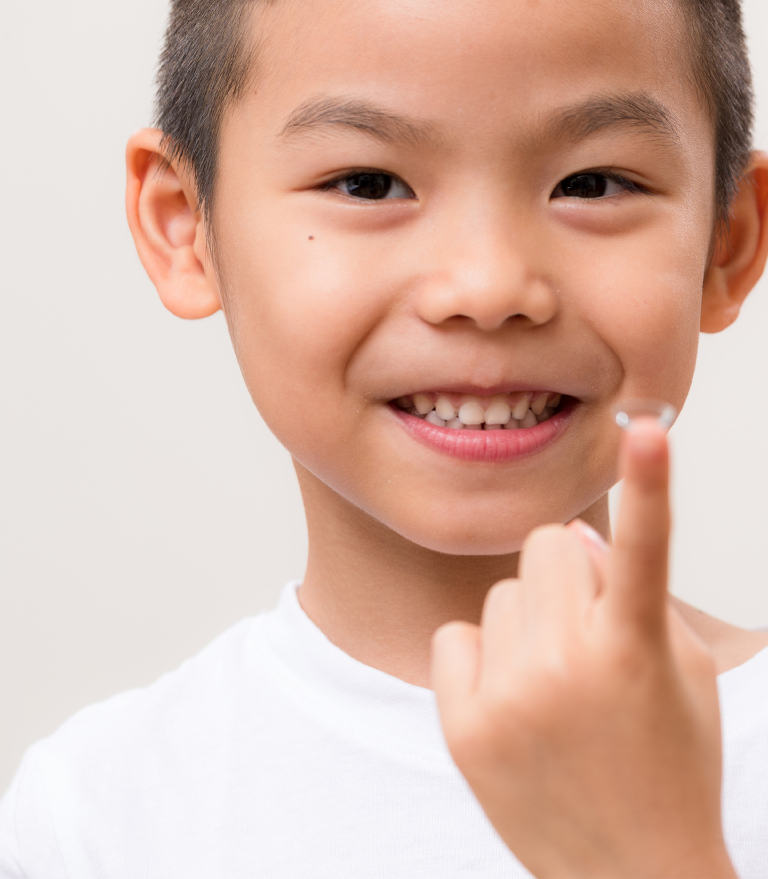 Boy with contact lens on finger